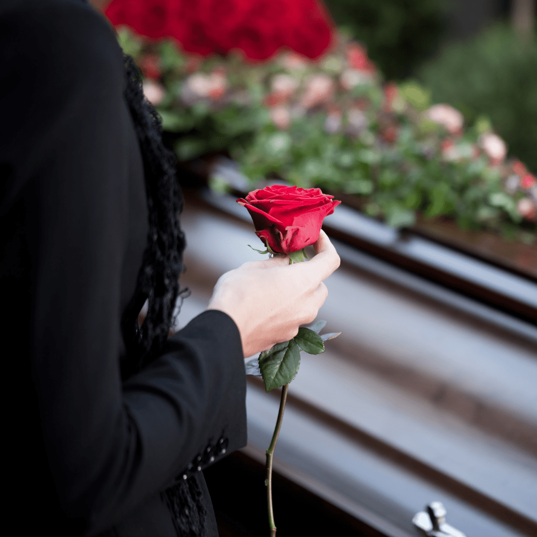 Person with Rose at a funeral